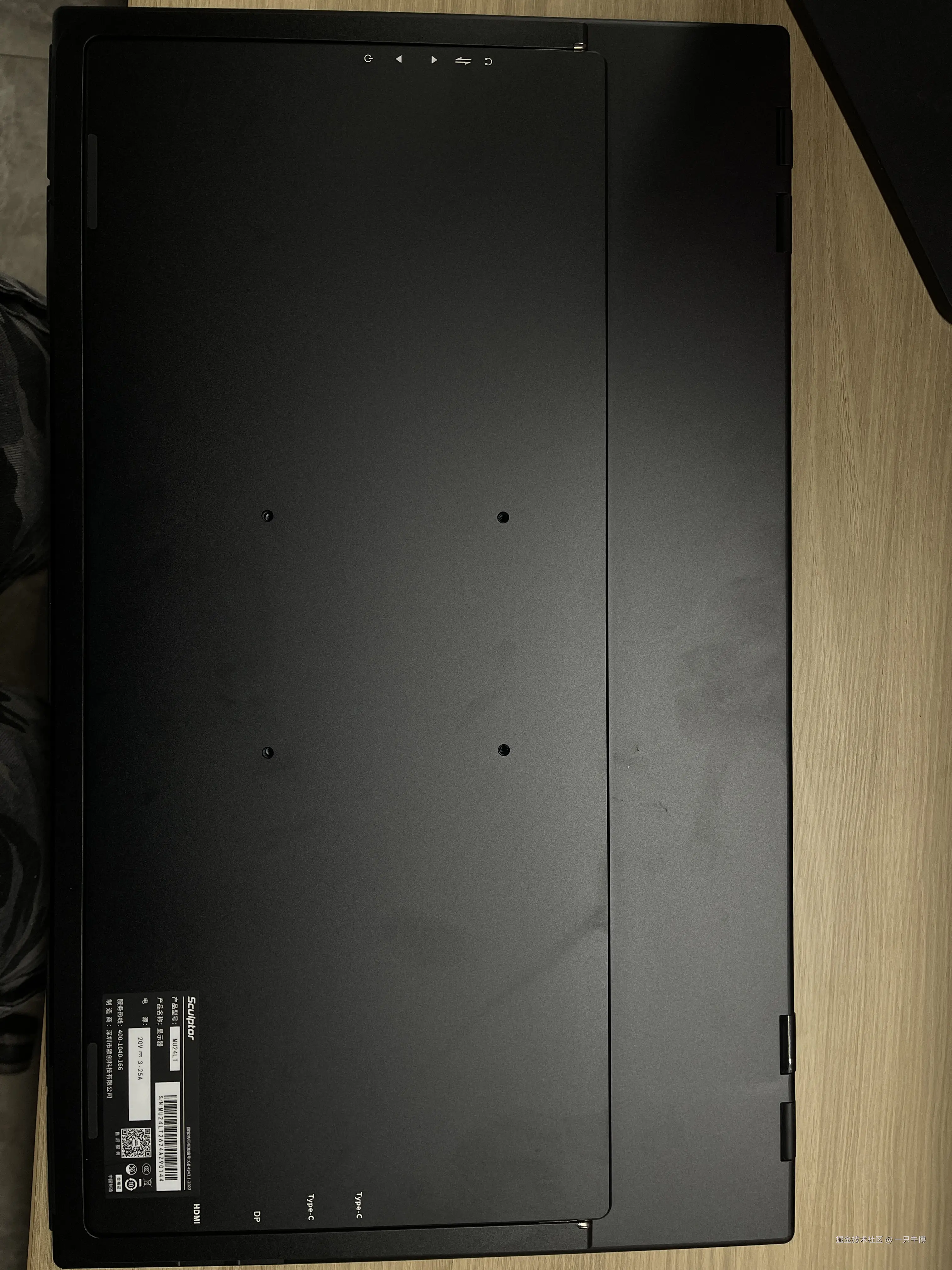 The back of the monitor, standard VESA mount holes, a row of ports: two Type-C, DP, HDMI