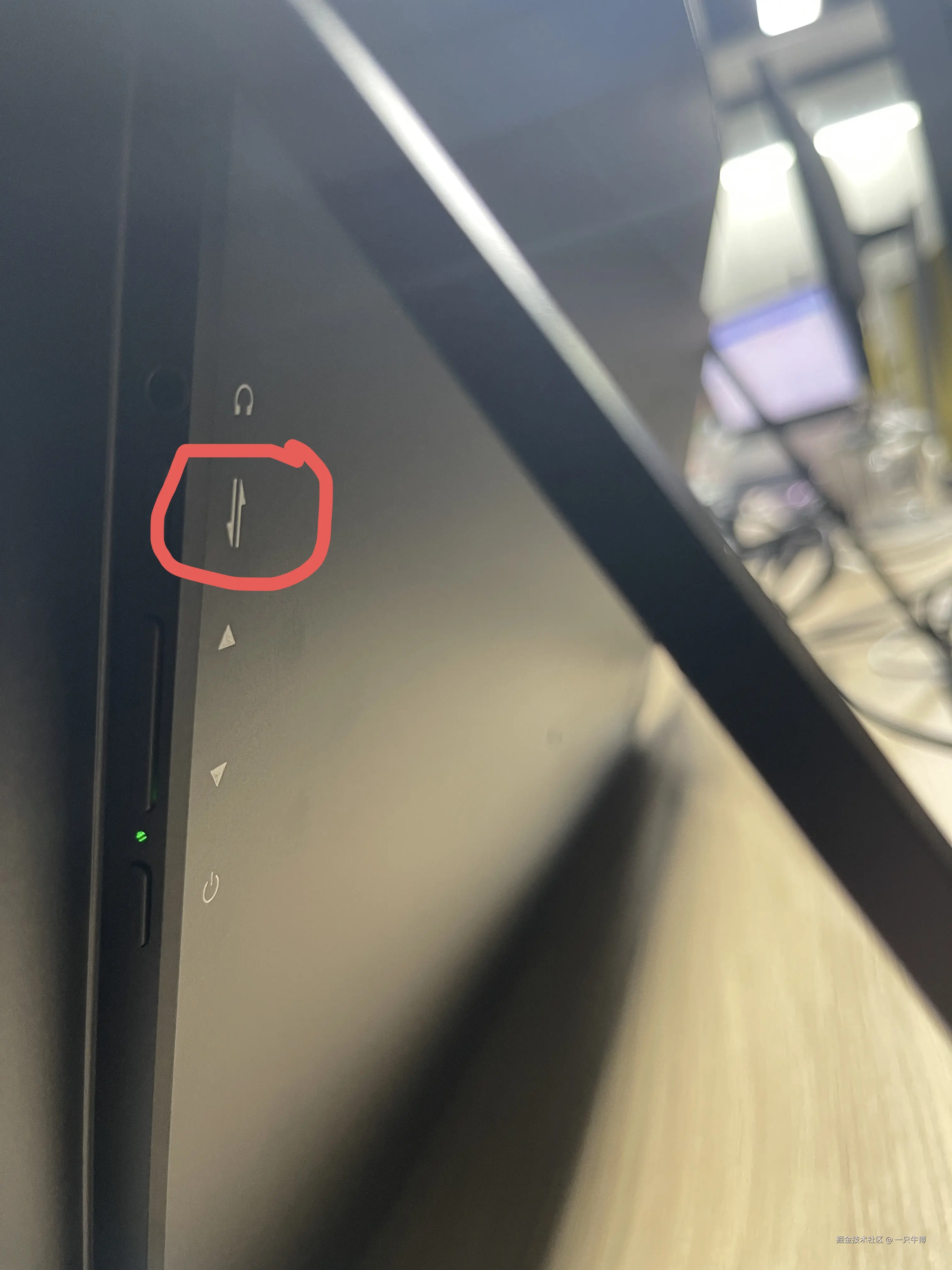 Close-up of the merge shortcut key on the side of the monitor, circled in red